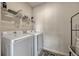 Bright laundry room with a washer, dryer, wire rack and storage space at 465 White Cotton Cir, Oviedo, FL 32765