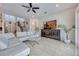 Bright, open-concept living room featuring tile floors, modern furniture, and staircase to the second floor at 465 White Cotton Cir, Oviedo, FL 32765