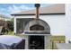 Outdoor pizza oven with stainless steel front and chimney perfect for entertaining friends and Gathering at 465 White Cotton Cir, Oviedo, FL 32765