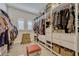 Spacious walk-in closet with custom shelving, drawers, baskets and ample hanging storage at 465 White Cotton Cir, Oviedo, FL 32765