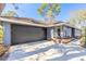 Charming one-story home with a large garage door and appealing curb appeal at 6205 Klondike Dr, Port Orange, FL 32127