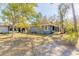 Charming single-story home with light blue siding and mature trees in a serene, natural setting at 6205 Klondike Dr, Port Orange, FL 32127