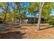 View of charming single-story home with mature landscaping and driveway, framed by mature trees at 68 Crooked Pine Rd, Port Orange, FL 32128