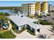 Aerial view of a building that includes a community pool and parking with the bay visible in the background at 7 Riverwalk Dr # 206, New Smyrna Beach, FL 32169
