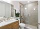 Well-lit bathroom featuring a glass enclosed shower with tiled walls, vanity and sink at 7 Riverwalk Dr # 206, New Smyrna Beach, FL 32169