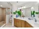 Bathroom with a double sink vanity, quartz countertop, wood cabinets, and walk-in shower at 7 Riverwalk Dr # 206, New Smyrna Beach, FL 32169