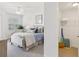 Bright bedroom featuring a cozy bed, ceiling fan, and a glimpse into an organized walk-in closet at 7 Riverwalk Dr # 206, New Smyrna Beach, FL 32169