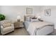 Comfortable bedroom with decorative pillows and art, side tables, and a plush armchair at 7 Riverwalk Dr # 206, New Smyrna Beach, FL 32169