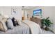 Bright bedroom with a dresser and TV, comfortable bedding, and a large houseplant at 7 Riverwalk Dr # 206, New Smyrna Beach, FL 32169