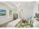 Bright bedroom with leaf patterned comforter and TV, offering a tranquil retreat at 7 Riverwalk Dr # 206, New Smyrna Beach, FL 32169