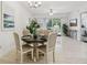 Well-lit dining room showcasing a round table set and a view into the bright living area at 7 Riverwalk Dr # 206, New Smyrna Beach, FL 32169