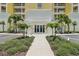 Welcoming entrance to building featuring manicured plants, flowers and paved walkway at 7 Riverwalk Dr # 206, New Smyrna Beach, FL 32169