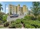 Yellow condominium complex with lush, green landscaping with ample parking at 7 Riverwalk Dr # 206, New Smyrna Beach, FL 32169