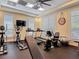 Bright community gym features various exercise machines, TV, and ample natural light from the windows at 7 Riverwalk Dr # 206, New Smyrna Beach, FL 32169