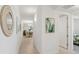 Inviting hallway featuring warm lighting, neutral colors and views into the dining area at 7 Riverwalk Dr # 206, New Smyrna Beach, FL 32169