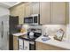 Close-up view of the kitchen, displaying the stainless steel appliances and elegant countertops at 7 Riverwalk Dr # 206, New Smyrna Beach, FL 32169