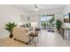 Bright and airy living room with neutral colors, ceiling fan and access to the balcony at 7 Riverwalk Dr # 206, New Smyrna Beach, FL 32169