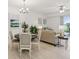 Open concept living and dining area featuring contemporary decor and access to outdoor balcony at 7 Riverwalk Dr # 206, New Smyrna Beach, FL 32169