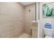 Tiled walk-in shower with a built-in bench and a rain shower head; toilet is next to shower at 7 Riverwalk Dr # 206, New Smyrna Beach, FL 32169