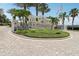 Attractive community sign featuring manicured landscaping and an American flag at 7 Riverwalk Dr # 206, New Smyrna Beach, FL 32169