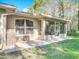 Charming exterior view of an enclosed patio with a tiled floor, screened windows, and ceiling fan at 1077 Crystal Creek Dr, Port Orange, FL 32128