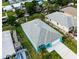Aerial view of bright blue home with grey roof, nearby waterway, and neatly kept lawn at 113 Douglas St, Edgewater, FL 32141