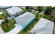 Birds-eye view of a turquoise house with a grey roof and a long driveway, close to the water at 113 Douglas St, Edgewater, FL 32141