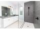 Modern bathroom features tiled shower and double sink vanity with dark countertops and sleek fixtures at 113 Douglas St, Edgewater, FL 32141