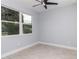 A clean, airy bedroom with a ceiling fan and a large window at 113 Douglas St, Edgewater, FL 32141