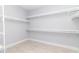 A walk-in closet with white, adjustable shelving at 113 Douglas St, Edgewater, FL 32141