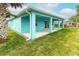 Exterior view of house featuring a spacious backyard with vibrant green grass at 113 Douglas St, Edgewater, FL 32141