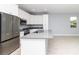 Modern kitchen features stainless steel appliances, white cabinetry, and gray countertops at 113 Douglas St, Edgewater, FL 32141
