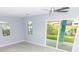 Living room features fan, windows for natural light, and sliding door with view of the yard at 113 Douglas St, Edgewater, FL 32141