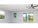 Open room featuring multiple windows and a sliding glass door leading to backyard at 113 Douglas St, Edgewater, FL 32141