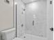 Modern bathroom with glass shower, white tile, and modern fixtures at 1227 Wayne Ave, New Smyrna Beach, FL 32168