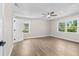 Comfortable bedroom with wood floors, ceiling fan, and natural light from windows at 1227 Wayne Ave, New Smyrna Beach, FL 32168