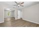 Bedroom with wood floors, sliding closet, and ensuite bathroom at 1227 Wayne Ave, New Smyrna Beach, FL 32168