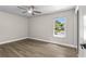 Bedroom with wood floors, natural light, and backyard view at 1227 Wayne Ave, New Smyrna Beach, FL 32168