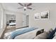 A bedroom boasting a ceiling fan, closet with sliding mirrored doors, and neutral color scheme at 1227 Wayne Ave, New Smyrna Beach, FL 32168