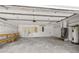 Spacious two-car garage with overhead storage, pegboard, and work bench at 1227 Wayne Ave, New Smyrna Beach, FL 32168