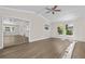 Bright living room with ceiling fan, wood floors, and large windows for natural light at 1227 Wayne Ave, New Smyrna Beach, FL 32168
