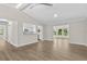Open living space with light wood flooring, connecting the kitchen and living areas at 1227 Wayne Ave, New Smyrna Beach, FL 32168