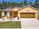 Charming single-Gathering home showcasing a well-kept lawn and inviting front entrance with a two-car garage at 1827 Palmetto Scrub Cir, Port Orange, FL 32128