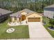 Inviting single-story home with an attached garage, manicured lawn, and a beautifully landscaped front yard at 1827 Palmetto Scrub Cir, Port Orange, FL 32128