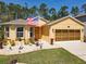 Charming yellow home featuring a well-manicured lawn, lovely landscaping and an inviting entrance at 1827 Palmetto Scrub Cir, Port Orange, FL 32128