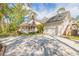 Beautiful home featuring a large front porch, attached garage, and a well-manicured lawn and mature trees at 1910 Botree Ct, Port Orange, FL 32128