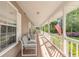 Inviting front porch features ample seating and an American flag, perfect for relaxing and enjoying the outdoors at 1910 Botree Ct, Port Orange, FL 32128