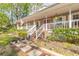 Charming front porch with comfortable seating, offering a relaxing outdoor space with stone walkway at 1910 Botree Ct, Port Orange, FL 32128