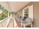 Inviting, relaxing porch with multiple chairs and a small table at 1910 Botree Ct, Port Orange, FL 32128