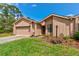 Charming home featuring a well-manicured lawn and garden in the front yard at 1928 Sprucewood Way # 58, Port Orange, FL 32128